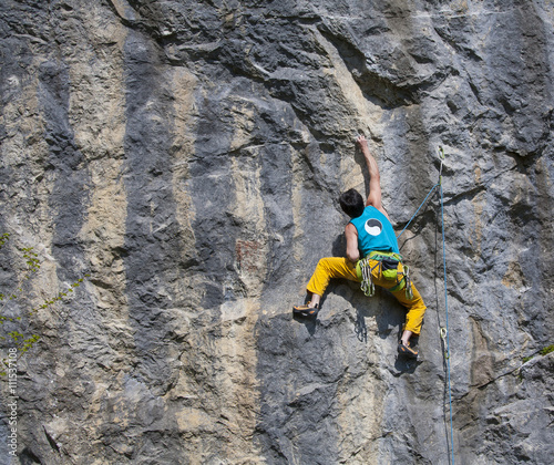 Mature climber on the wall.