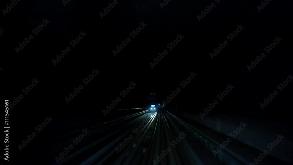 Train goes through a tunnel. Oncoming train inside tunnel. The Dubai Metro is a driverless, fully automated metro network. The view through the front window. Dubai is a city and emirate in UAE