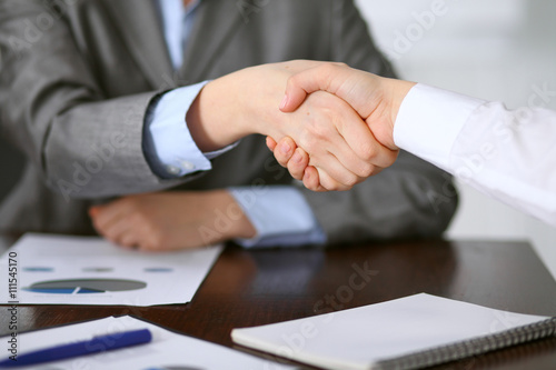 Close up of unknown business people handshake