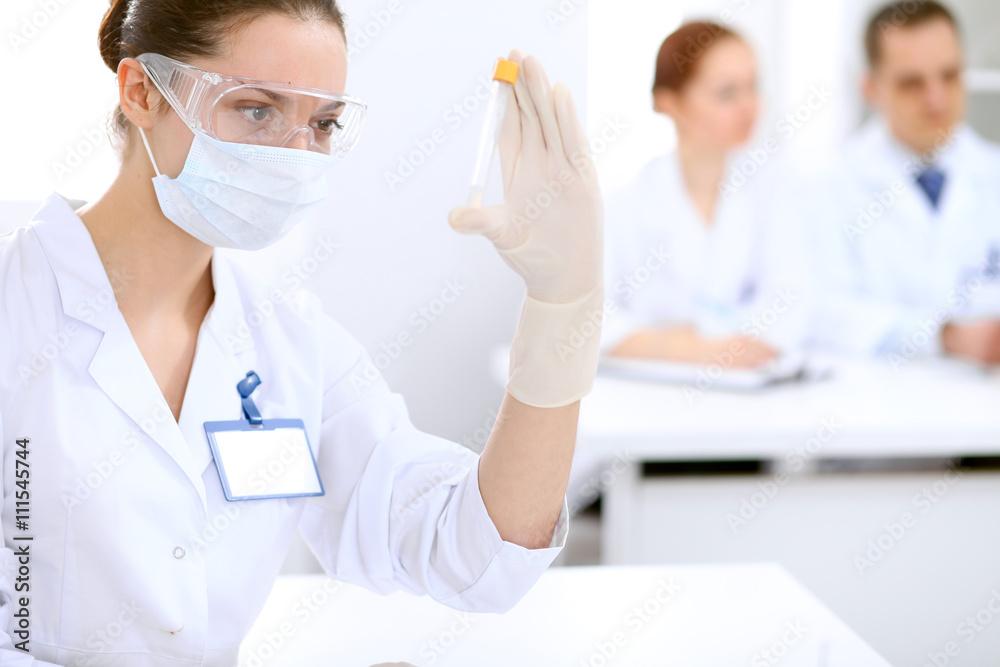 Scientific research team with clear solution in laboratory Scientific research team with clear solution in laboratory