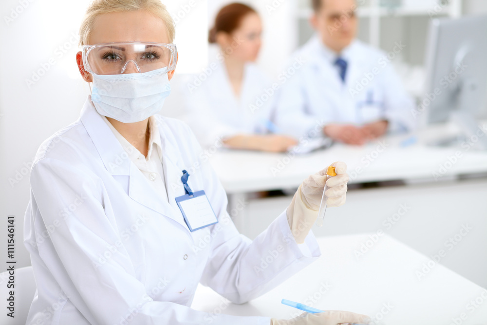 Scientific research team with clear solution in laboratory Scientific research team with clear solution in laboratory