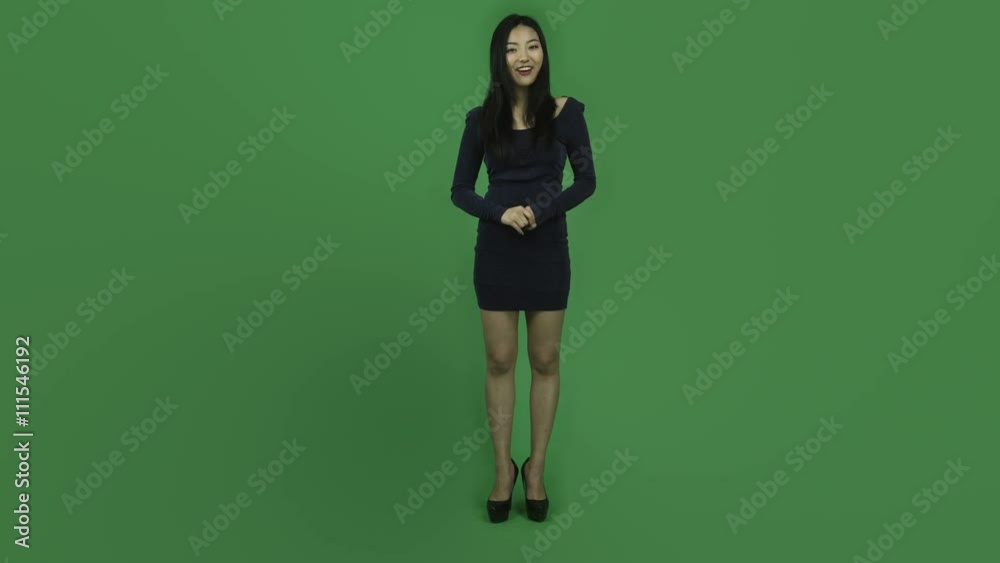 Asian girl young adult evening dress isolated greenscreen green background interview talking presenting Asian girl young adult evening dress isolated greenscreen green background interview talking presenting
