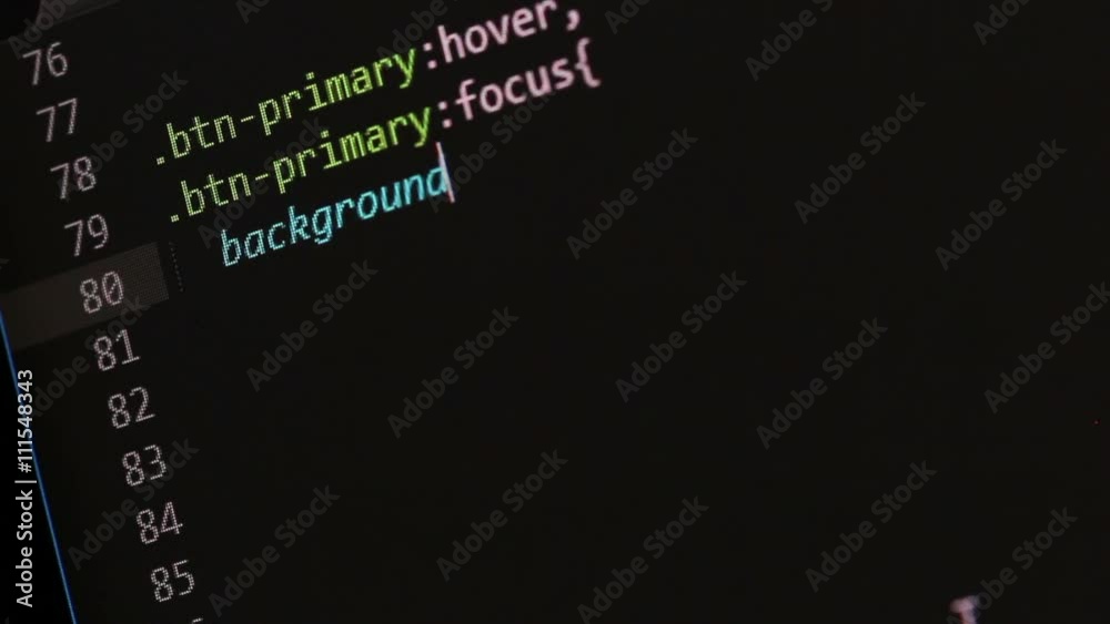 Closeup video of a freelancers computer screen while writing CSS code from scratch, in this case a default primary button and a transparent button style.