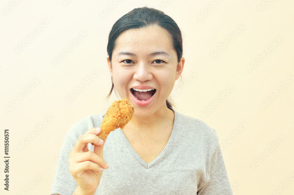 Young happy woman holding and eating fries chicken, vintage tone Young happy woman holding and eating fries chicken, vintage tone