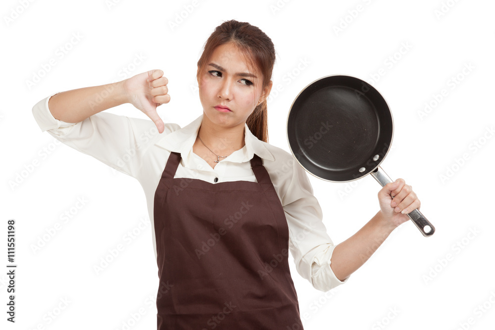 Asian girl cooking thumbs down with frying pan Asian girl cooking thumbs down with frying pan