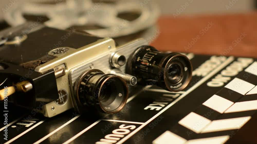 Movie clapper lie with retro camera and movie films on reels. film Production