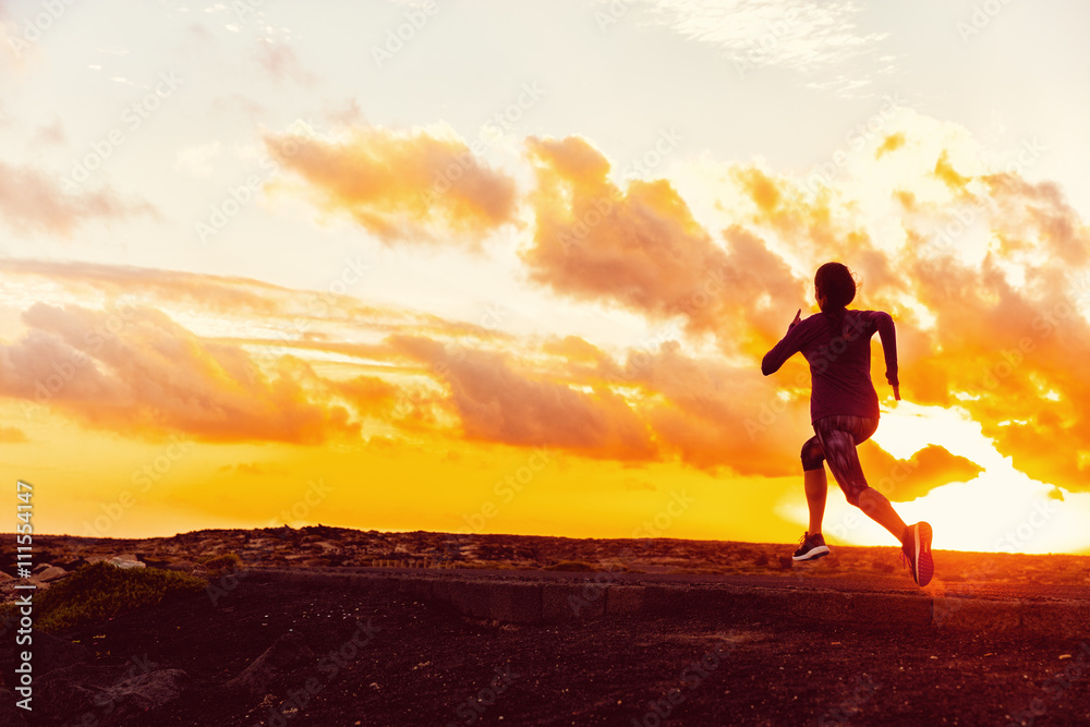 Athlete trail running silhouette of a woman runner at sunset sunrise. Cardio fitness training for marathon race. Active healthy lifestyle in summer nature outdoors. Goal achievement challenge concept.