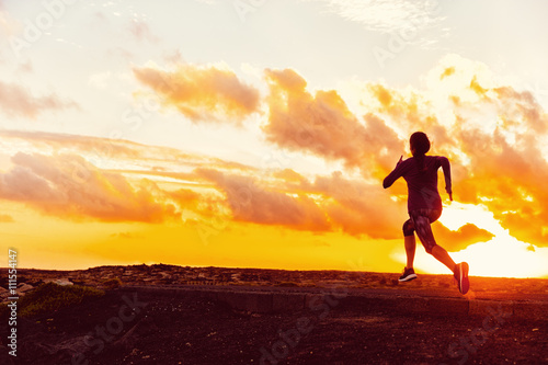 Athlete trail running silhouette of a woman runner at sunset sunrise. Cardio fitness training for marathon race. Active healthy lifestyle in summer nature outdoors. Goal achievement challenge concept.