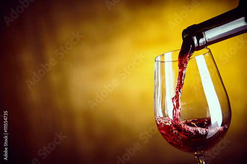 Serving a glass of red wine from a bottle