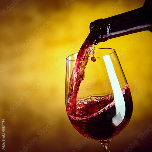 Dispensing red wine from a bottle photo