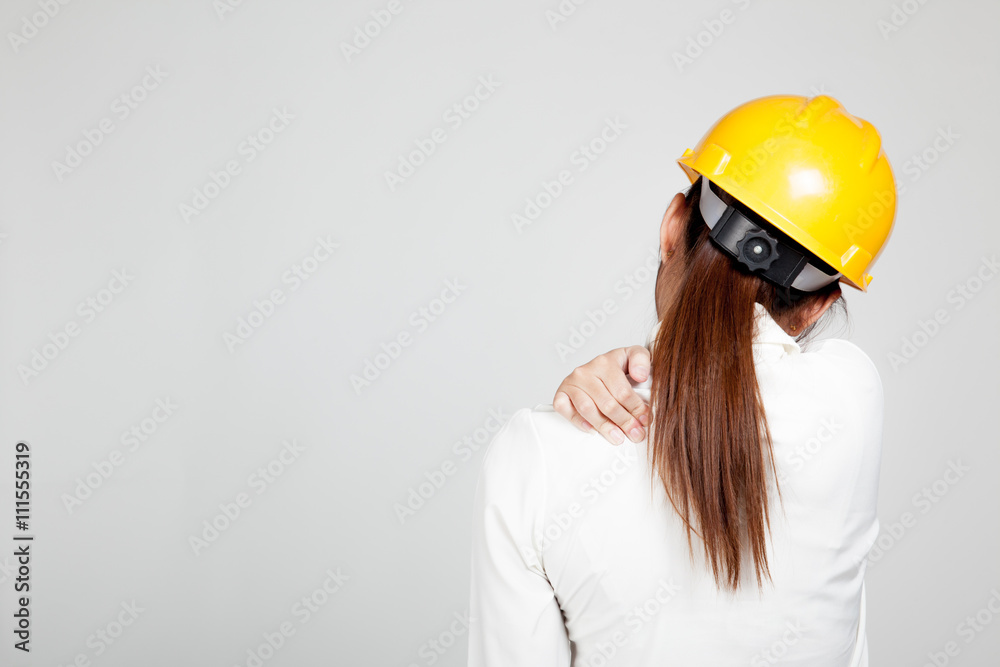 Back of Asian Engineer girl with hard hat got back pain Back of Asian Engineer girl with hard hat got back pain