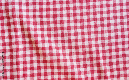 Red crumpled picnic tablecloth background.