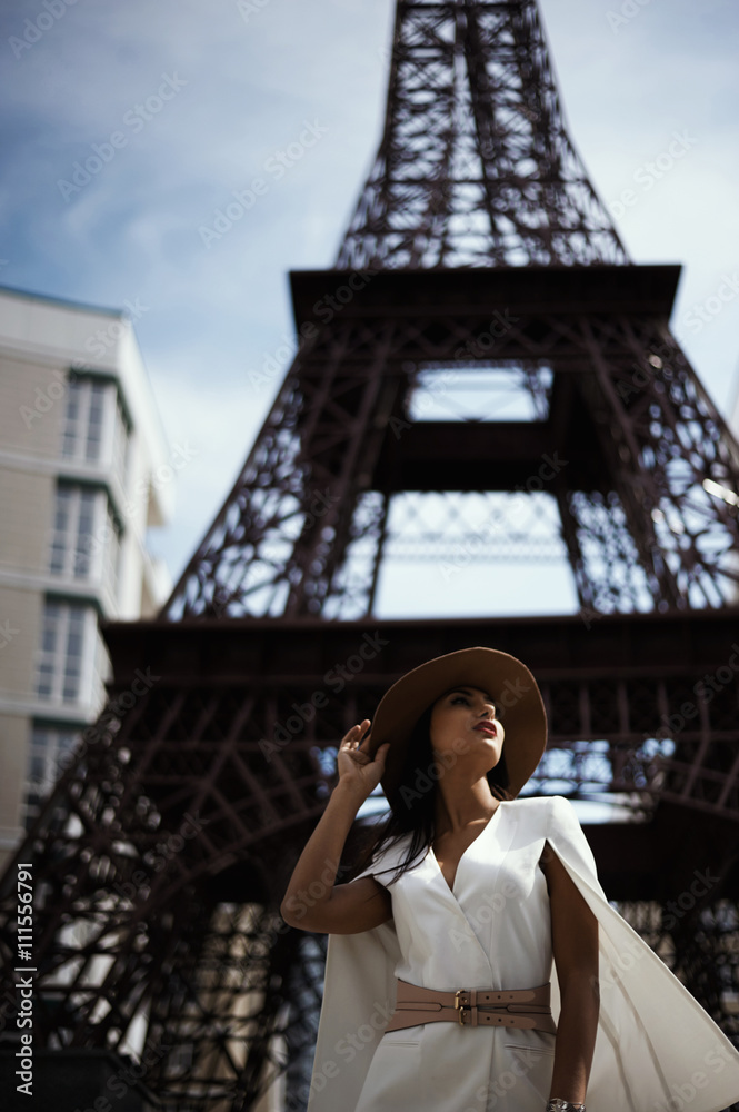  raven haired indian lady posing against fake Eiffel Tower