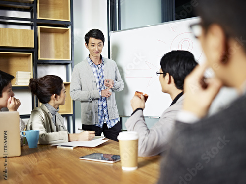 young asian businessman facilitating a workshop discussion