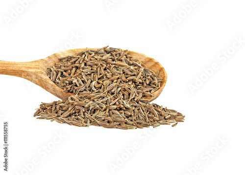 Сumin seeds in wooden spoon on a white background