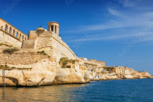 Sunny view of Siege Bell War Monument from the sea.