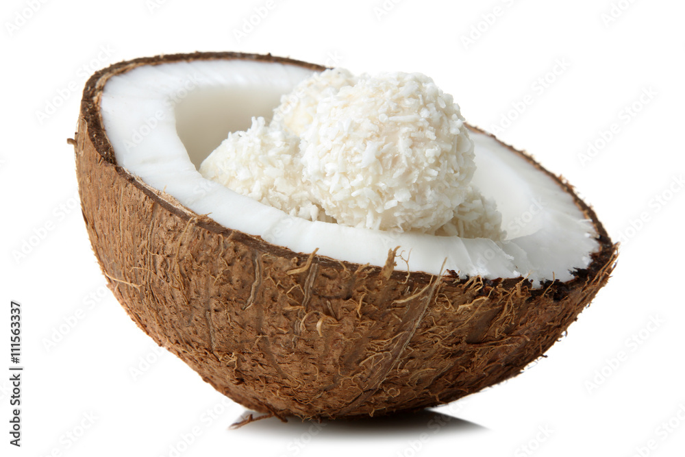 half coconut with coconut candies on white isolated background half coconut with coconut candies on white isolated background
