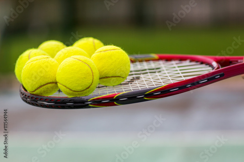 Tennis Balls on a Racket Close Up © sichkarenko_com