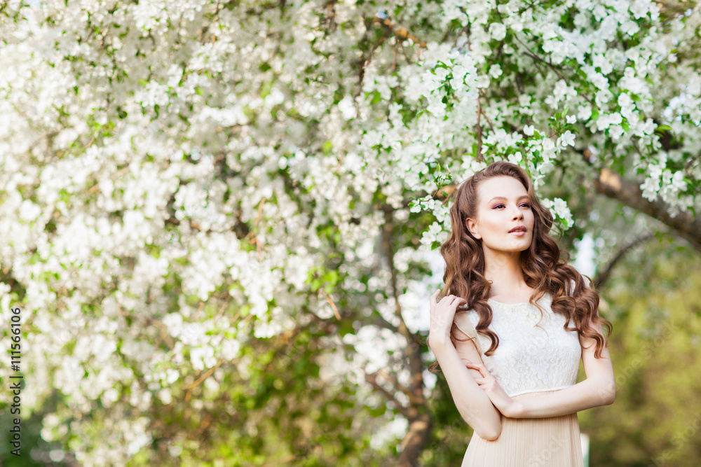 Young beautiful girl posing near apple-tree in blossom Young beautiful girl posing near apple-tree in blossom