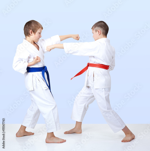Boys beat punch arm toward each other