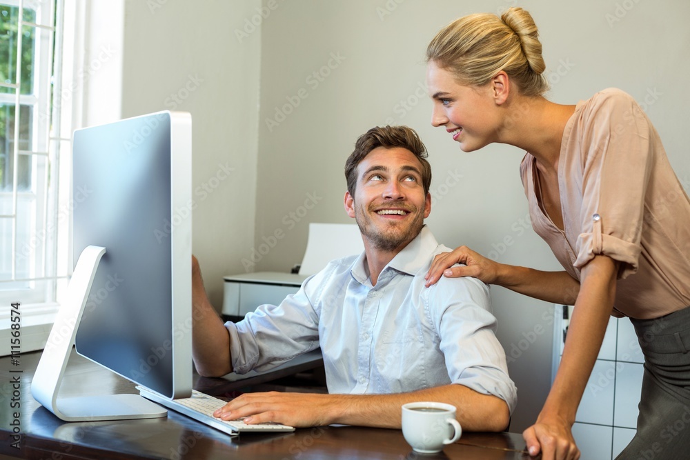 Happy colleagues discussing at office Happy colleagues discussing at office