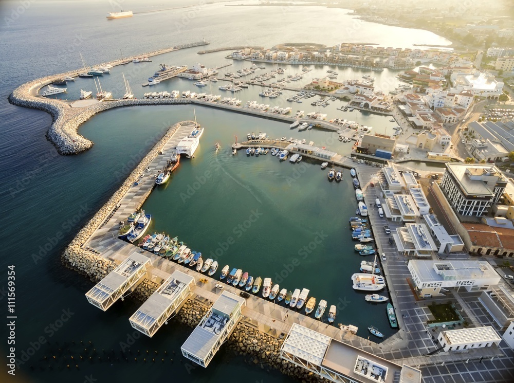 Aerial view of fishing boats docked at the Limassol old port (palio limani) in Cyprus, next to the Marina part of the ports authority. The harbor, Mediterranean sea,water, restaurants and coffee shops