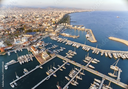 Aerial view of the beautiful Marina in Limassol city in Cyprus,beach,boats,piers,villas, commercial area,old port (palio limani) and Molos. A modern,high end,newly developed space with docked yachts.