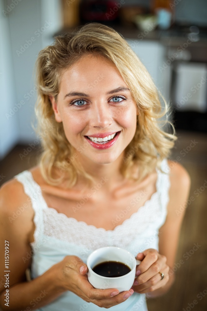 Portrait of young woman holding coffee cup Portrait of young woman holding coffee cup