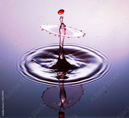 Water drop photography, one or two drops of water dropped from height into water and captured as they hit the water or collide with each other. photo