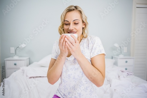 Woman having coffee in bed