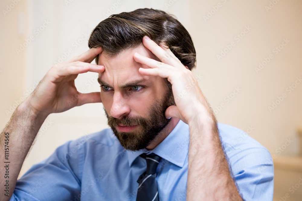 Close up of tensed man with hands on forehead Close up of tensed man with hands on forehead