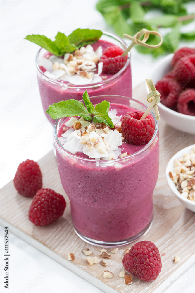 fresh berry smoothies with nuts on white board, top view fresh berry smoothies with nuts on white board, top view