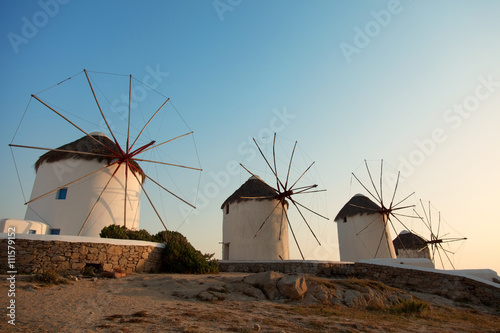 Row of four windmills at sunset in Mykonos island, Greece