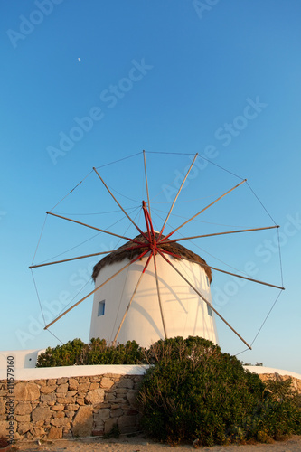 Windmill in front of a blue sky in Mykonos island, Greece at sunset. Vertical shot.