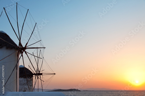 Two windmills at sunset in Mykonos island, Greece