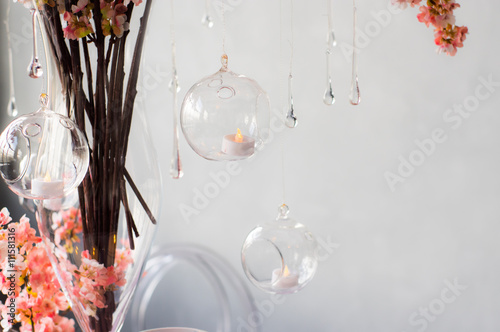 Wedding decoration for banquet with pink sakura, candles, glass drops