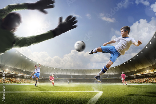 Childrens are playing soccer on grand arena photo