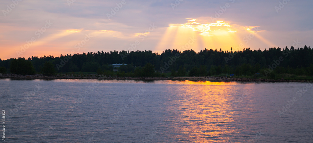 Sunset over Baltic Sea coast, sunbeams