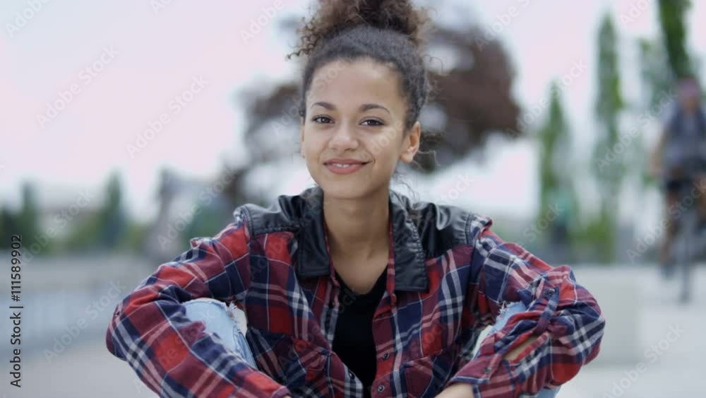 Portrait of a young african american woman wearing checkered shirt, outdoors. Portrait of a young african american woman wearing checkered shirt, outdoors.