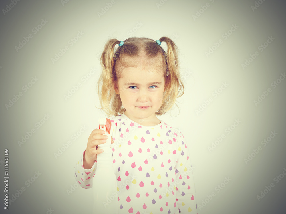 Little girl holding a watering spray bottle Little girl holding a watering spray bottle