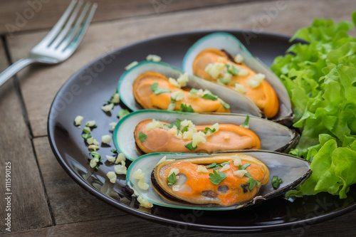 Baked mussels with garlic on plate