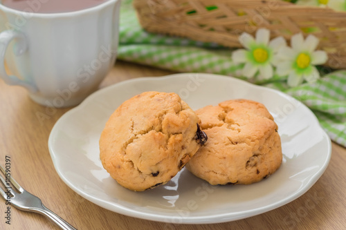 Scones on plate and cup of tea