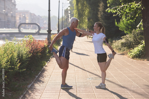 couple warming up and stretching before jogging