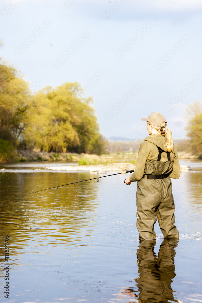 woman fishing in the river in spring woman fishing in the river in spring