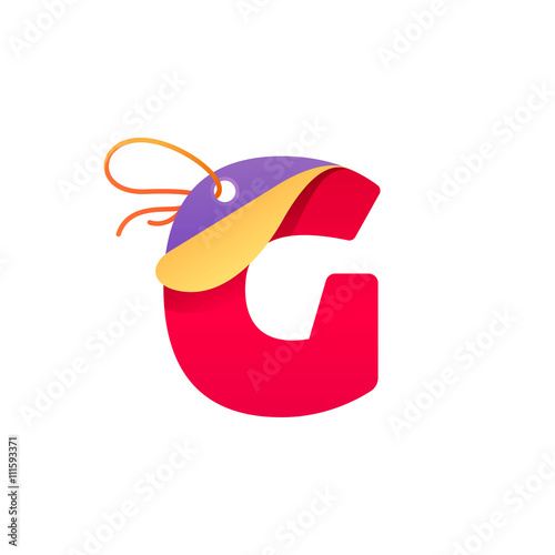G letter with paper folded corner and sale tag.