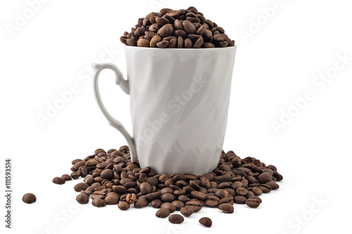 White coffee cup and spilled coffee-beans isolated on white