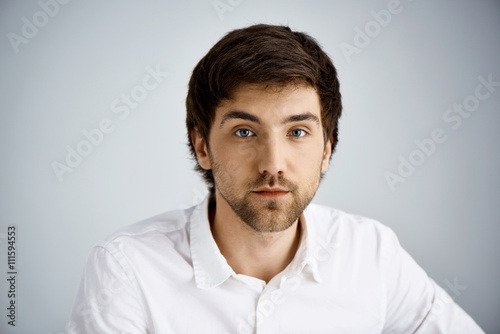 Close up portrait of elegant handsome young businessman looking