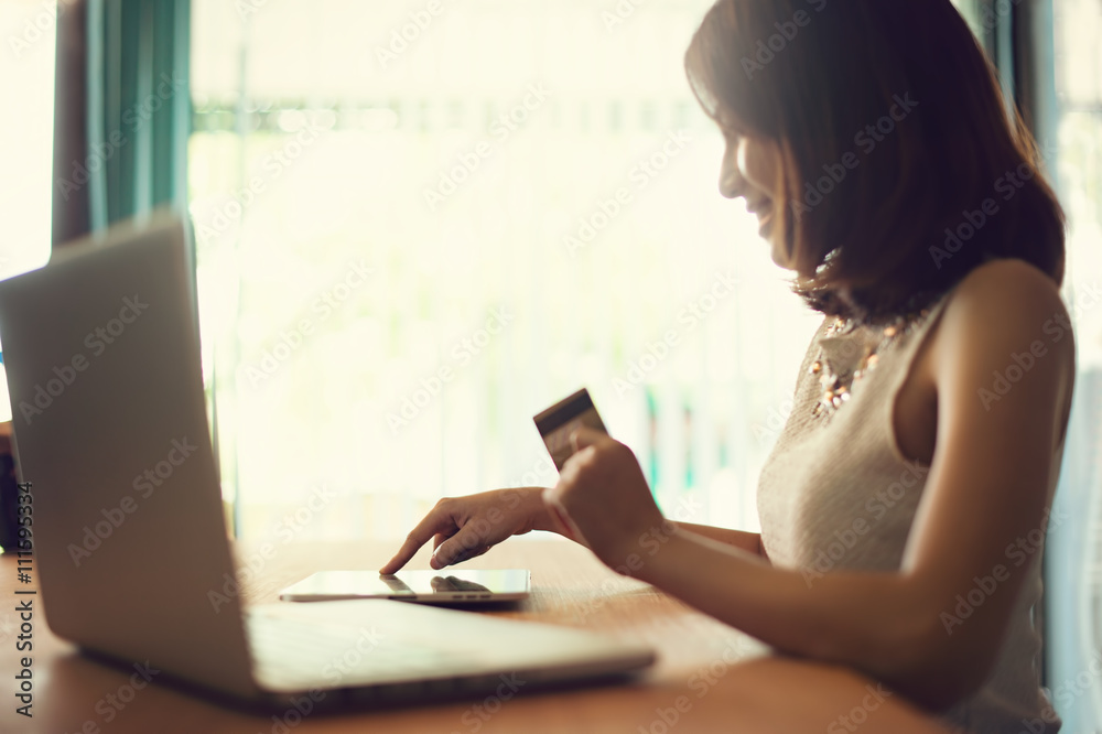 Internet of things, Shopping online, business online. Hand holding credit card doing business on line with laptop PC. Vintage filter. Internet of things, Shopping online, business online. Hand holding credit card doing business on line with laptop PC. Vintage filter.
