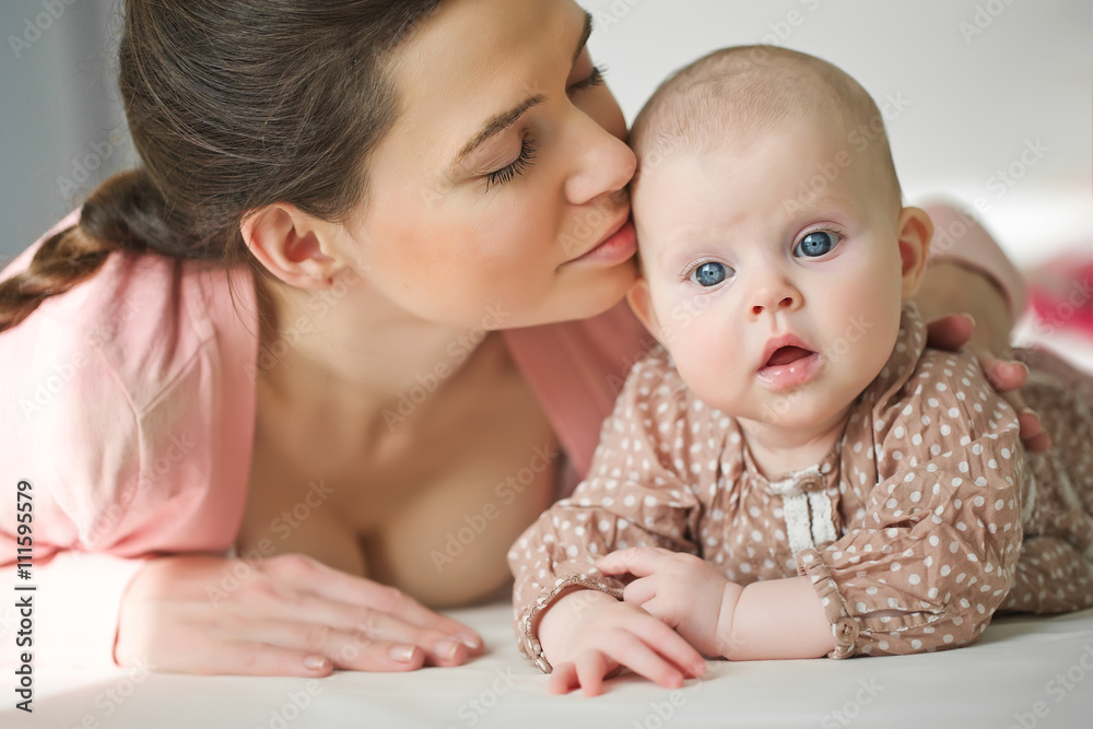 Happy mother with her baby on the badroom Happy mother with her baby on the badroom