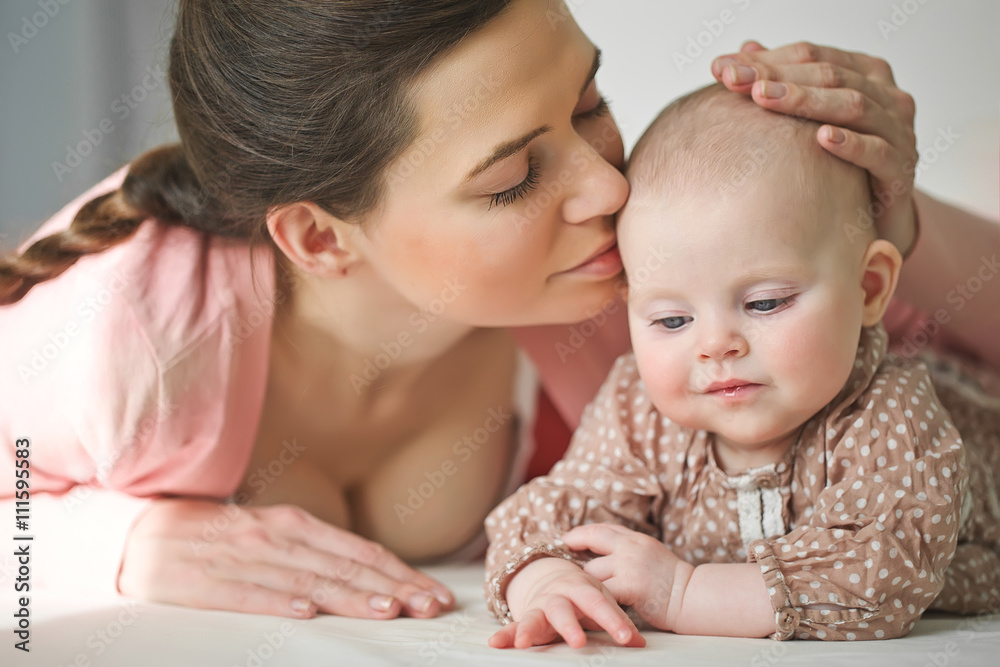 Happy mother with her baby on the badroom Happy mother with her baby on the badroom
